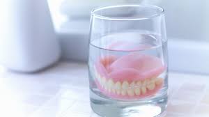 Is it OK to sleep with dentures in place?